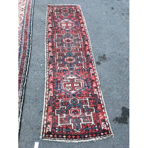 15 - A camel ground woollen Runner 14ft 4in L x 2ft 8in W and another red ground Runner with geometric de... 