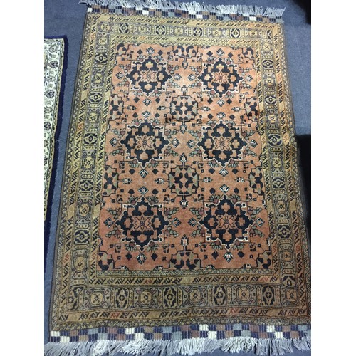 16 - A brown Oriental Rug with two rows of stylised flowers within tramline border 5ft 4in L x 3ft 4in W ... 