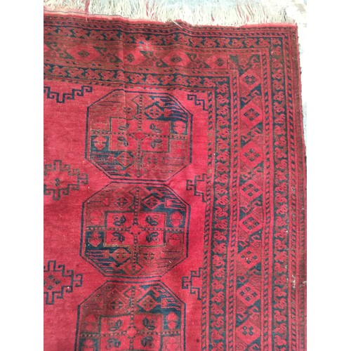 29 - A red ground Afghan Rug, approx 9ft 4in L x 6ft 1in W