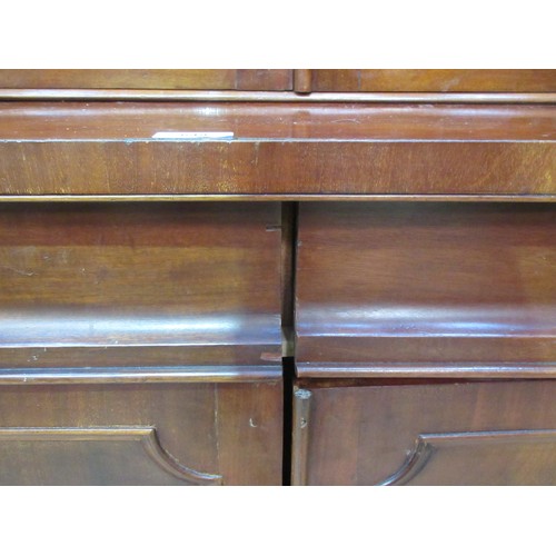 649 - A Victorian mahogany veneered Bookcase the upper section fitted two glazed doors enclosing adjustabl... 