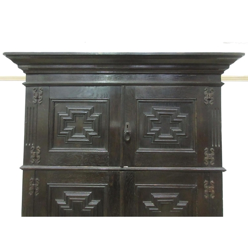 303 - A moulded oak Cupboard in the 17th Century style fitted pair of small doors above two large doors 6f... 