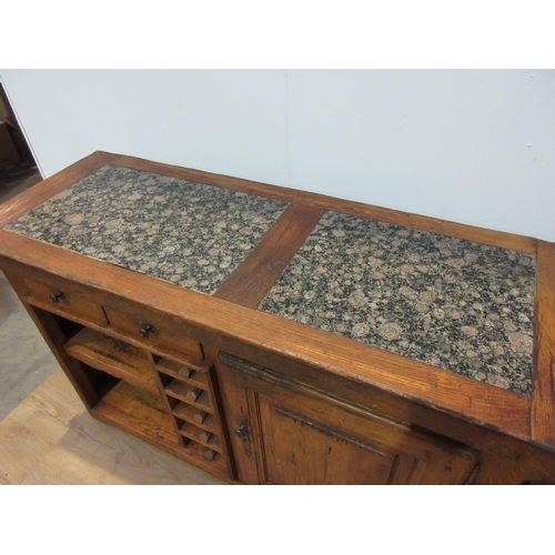 306 - An oak Kitchen Island with granite inset work surfaces fitted single drawer and a panelled cupboard ... 