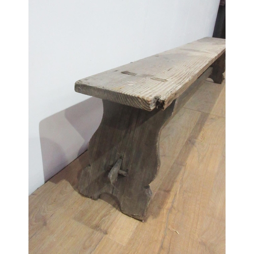 314 - A long pine Refectory Bench with shaped supports and stretchers, 8ft L x 10 1/2in W (one corner A/F)