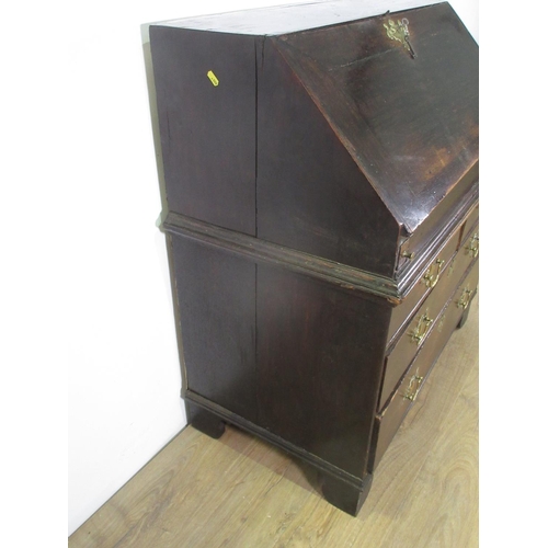 326 - An 18th Century oak Bureau with sloping front enclosing a fitted interior including a well, above tw... 