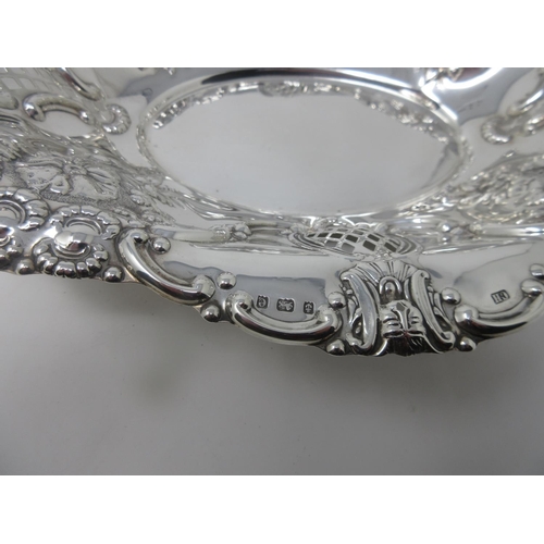 353 - An Edward VII silver oval Fruit Basket with floral embossing and piercing, Birmingham 1904, 316 gms.