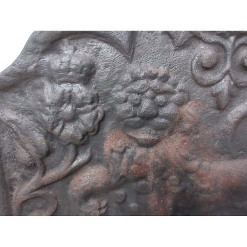 384 - A cast iron Fireback in the 17th Century style with lion and thistle relief decoration 2ft 7in W x 2... 