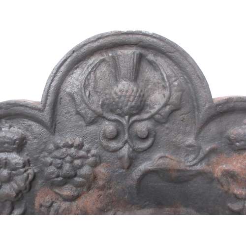 384 - A cast iron Fireback in the 17th Century style with lion and thistle relief decoration 2ft 7in W x 2... 