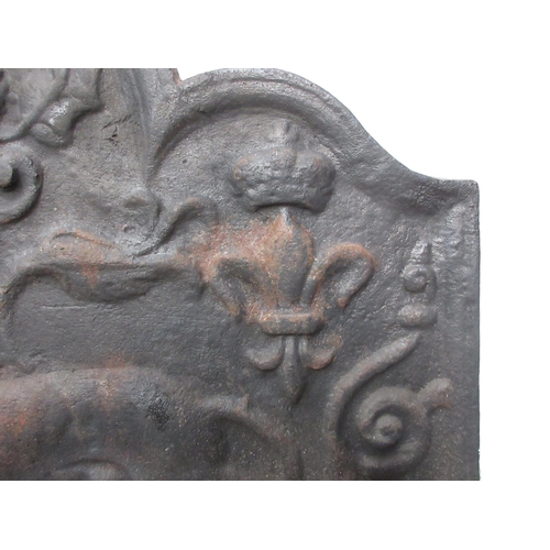 384 - A cast iron Fireback in the 17th Century style with lion and thistle relief decoration 2ft 7in W x 2... 