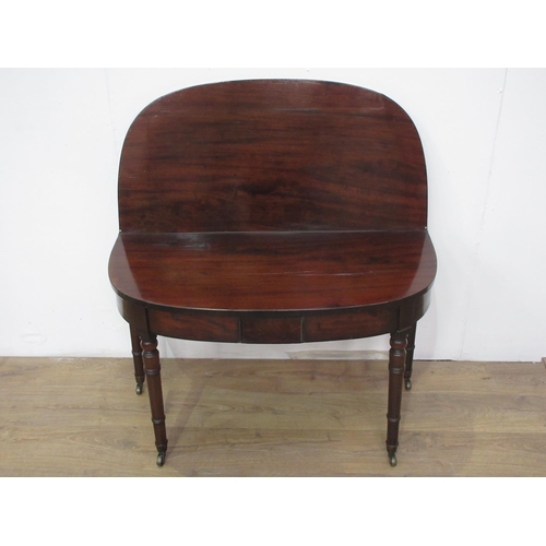 400 - A 19th Century mahogany fold-over Tea Table on ring turned supports and casters, 3ft 3in W