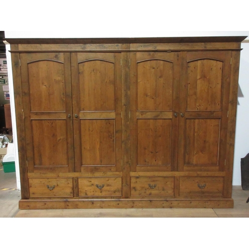 403 - A large reclaimed pine Wardrobe with moulded cornice, four panelled doors and fitted drawers to base... 