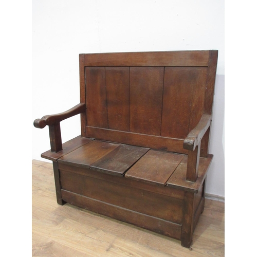 435 - An antique oak and fruitwood Box Settle with single panel back above seat fitted two sliding covers ... 