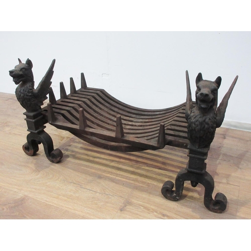 477 - A pair of cast iron Fire Dogs in the form of Griffins with grate 1ft 3in L