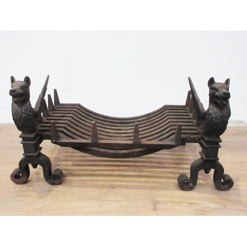 477 - A pair of cast iron Fire Dogs in the form of Griffins with grate 1ft 3in L