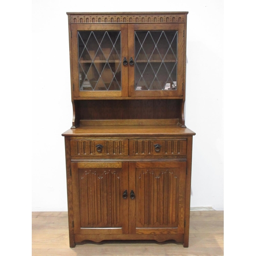 507 - A modern oak and lead glazed Dresser and Rack fitted two glazed doors to upper section above base fi... 