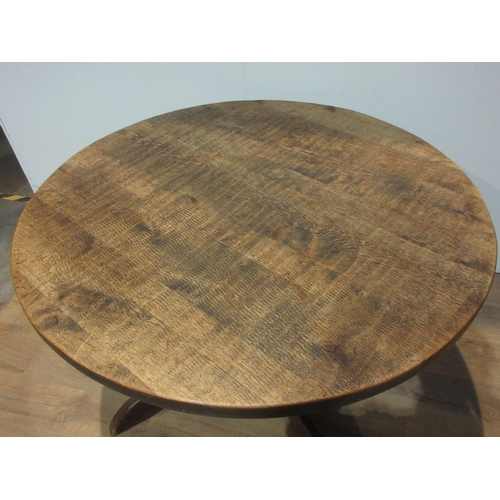 509 - An oak circular Breakfast Table mounted on four heavy supports 3ft 11in D x 2ft 5in H