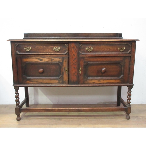 520 - A 20th Century oak Sideboard fitted two frieze drawers above pair of moulded panel doors mounted upo... 