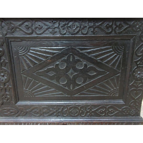 531 - A Victorian carved oak Settle with arcaded back beneath scallop and scroll carved top rail above a b... 