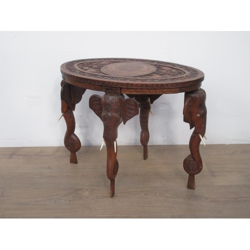 578 - An Eastern carved elephant leg Table.