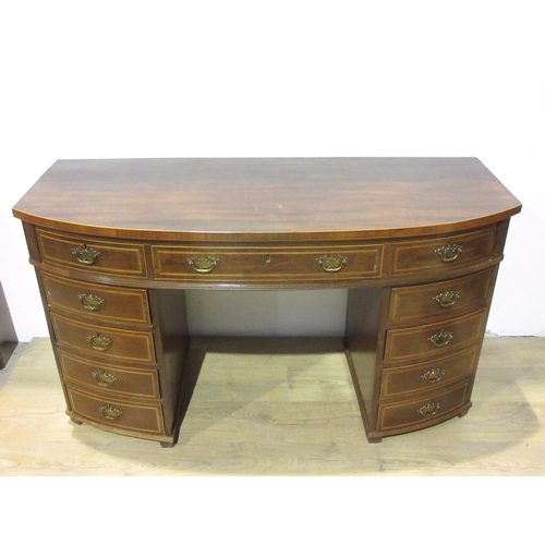 580 - A 19th Century mahogany bowfront Desk fitted eleven drawers 4 ft 9 in W x 2 ft 8 in H x 1 ft 10 in D... 