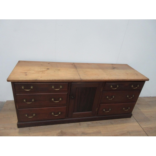 631 - A Victorian pitch pine Dresser Base fitted two banks of three drawers flanking a panel cupboard door... 