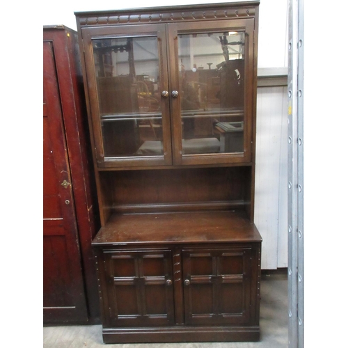 635 - A modern oak veneered and glazed Bookcase above base fitted pair of panelled cupboard doors 6ft 5in ... 