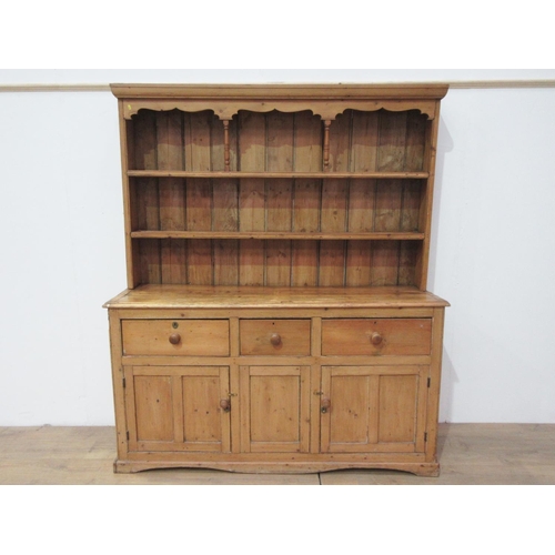 639 - A Victorian pine enclosed Dresser and Rack the base fitted three frieze drawers above a pair of pane... 