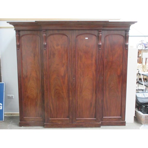 652 - A good quality Victorian flame mahogany Breakfront Wardrobe fitted four arched panel doors, the cent... 