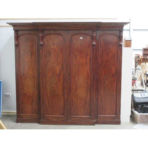 652 - A good quality Victorian flame mahogany Breakfront Wardrobe fitted four arched panel doors, the cent... 