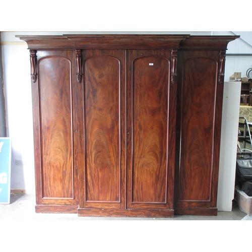 652 - A good quality Victorian flame mahogany Breakfront Wardrobe fitted four arched panel doors, the cent... 