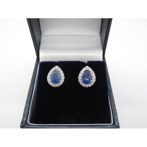 100 - A pair of Sapphire and Diamond Cluster Earrings each claw-set pear-cut sapphire, total sapphire weig... 