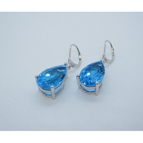 111 - A pair of Blue Topaz Ear Pendants, each claw-set, single pear-cut stone, total topaz weight 22.69cts... 