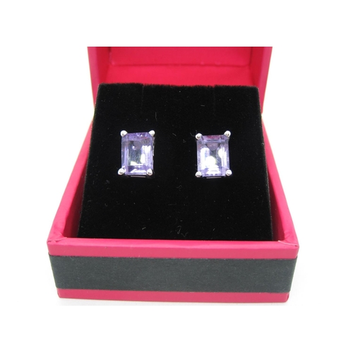 117 - A pair of Amethyst Ear Studs, each corner claw-set step-cut stone in silver.