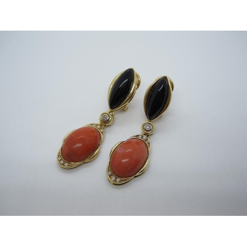 124 - A pair of Onyx, Diamond and Coral Earrings, each having marquise-shaped black onyx cabochon above ru... 