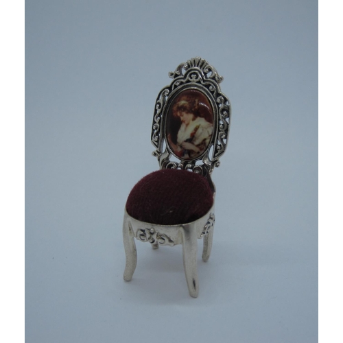 129 - A modern silver novelty Pin Cushion formed as a miniature chair with red velvet seat and enamel half... 