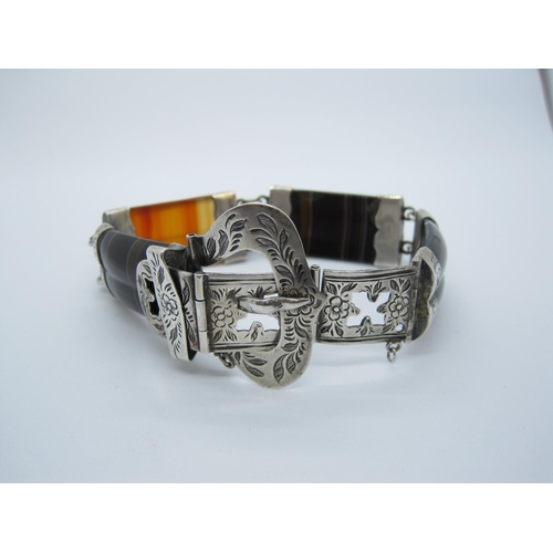 84 - A banded Agate Bracelet having four rectangular round topped stones, joined by engraved white metal ... 