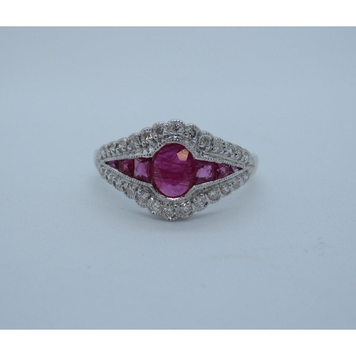 98 - A Ruby and Diamond Ring millegrain-set oval-cut ruby between tapered ruby baguettes within a frame o... 