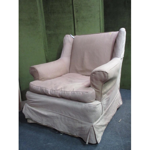 24 - A wingback Armchair mounted upon square cut supports with beige loose cover 3ft W x 2ft 11in H x 3ft... 