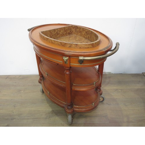 338 - A reproduction oval drinks Trolley with cooler to the upper tier and having brass fittings, 3ft 9in ... 