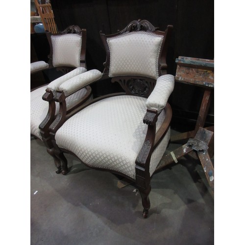 440 - A pair of Victorian walnut framed Elbow Chairs with leafage carved toprail and arms mounted upon cab... 