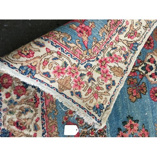 17 - A cream ground Rug with blue central decoration and border 6ft 4in L x 4ft 6in W and a small blue Ru... 