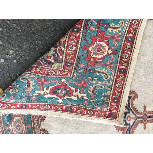 17 - A cream ground Rug with blue central decoration and border 6ft 4in L x 4ft 6in W and a small blue Ru... 