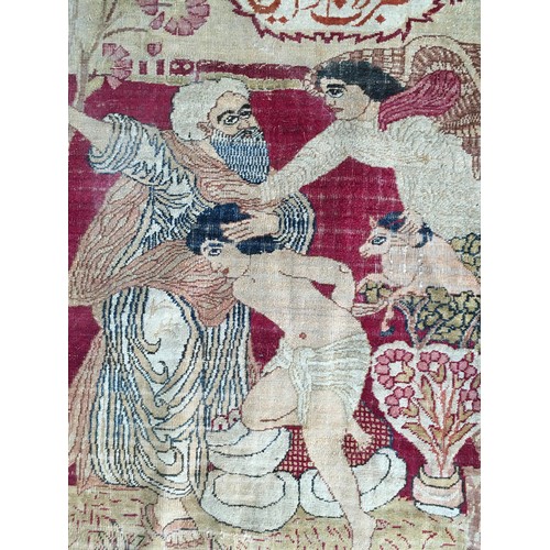 20 - An antique needlework Panel depicting sacrificial scene with Arabic lettering 2ft 5in L x 1ft 11in W