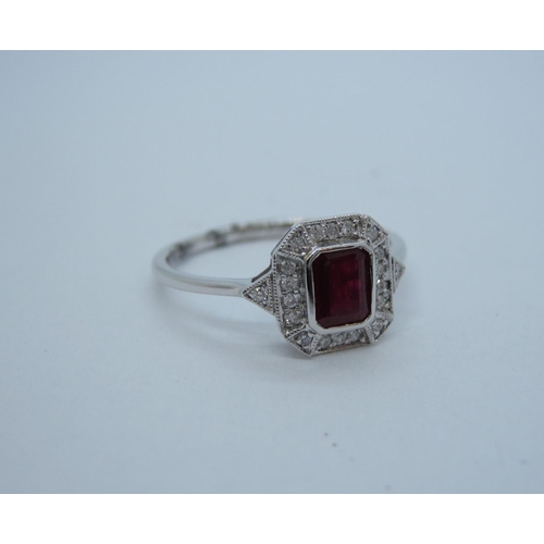 166 - An Art Deco style Ruby and Diamond Cluster Ring rubover-set step-cut ruby within frame of millegrain... 