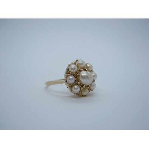 167 - A cultured Pearl Flower Cluster Ring set central pearl within eight smaller pearls, stamped 15c, rin... 