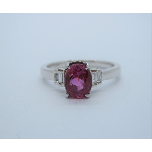 170 - A Pink Sapphire and Diamond Ring claw-set oval-cut sapphire, 1.51cts between two pairs of graduated ... 