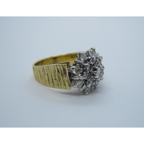 183 - A Diamond Flower Cluster Ring claw and illusion-set brilliant-cut stones in textured 18ct gold shank... 