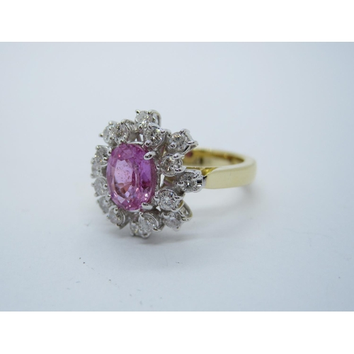 197 - A Pink Sapphire and Diamond Cluster Ring claw-set oval-cut pink sapphire, 1.23cts, within two tier f... 