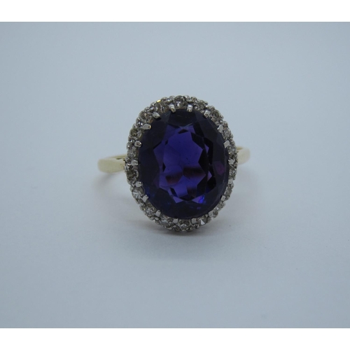 200 - An Amethyst and Diamond Cluster Ring claw-set oval-cut amethyst within frame of eight-cut diamonds s... 