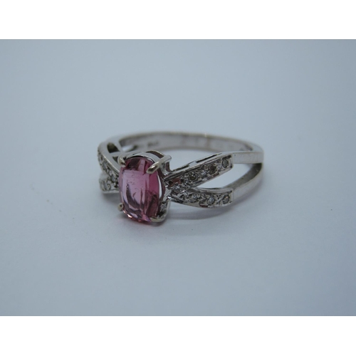 204 - A split shank Dress Ring claw-set oval-cut pink stone with illusion-set diamonds to shoulders in 18c... 