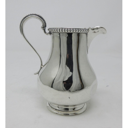 231 - A Victorian silver baluster Jug with beaded rim and scroll handle, London 1863, 160 gms, dented.